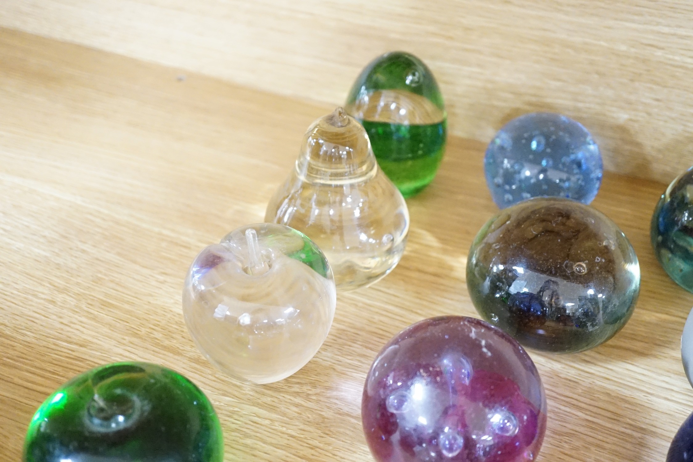 A collection of mixed paperweights to include a faceted floral Perthshire example, other Scottish floral and millefiori examples (Qty), tallest 12cms high